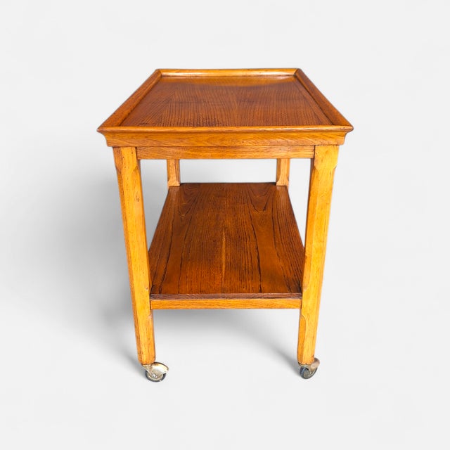 Oak bar cart made in Italy in the 1960s. The cart has two shelves: the lower one is 25 cm from the floor, the upper one 56...