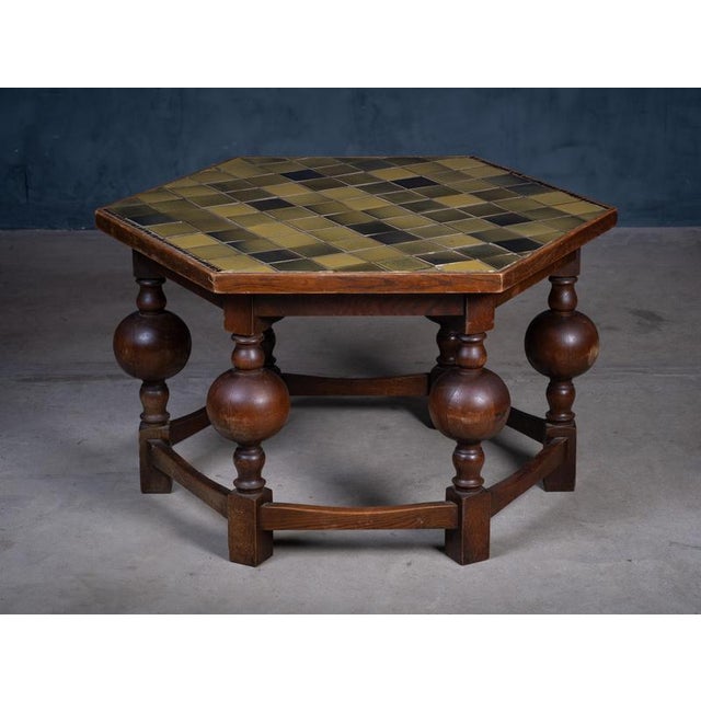Octagonal coffee table from the 1930s, crafted in solid oak with decorative tile inlays. In good vintage condition with...