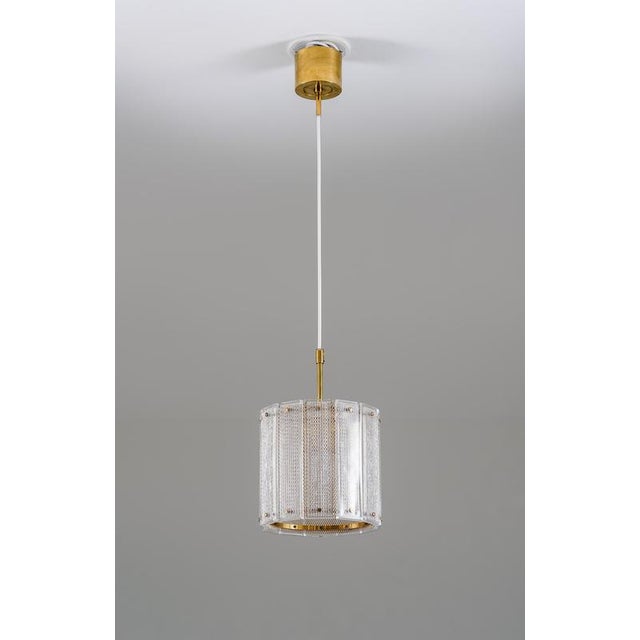 Elegant pair of swedish pendants from the 1960s, produced by falkenbergs belysning. Each lamp features a cylindrical shade...