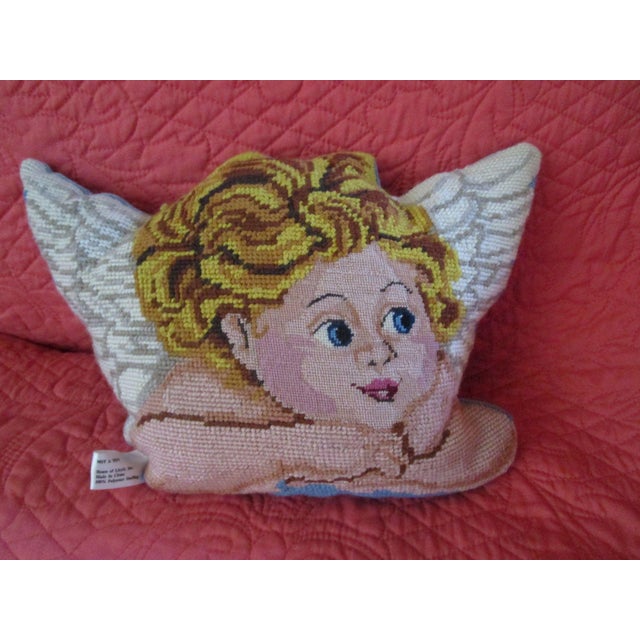 This charming decorative pillow features a meticulously crafted needlepoint golden haired angel face with wings design...