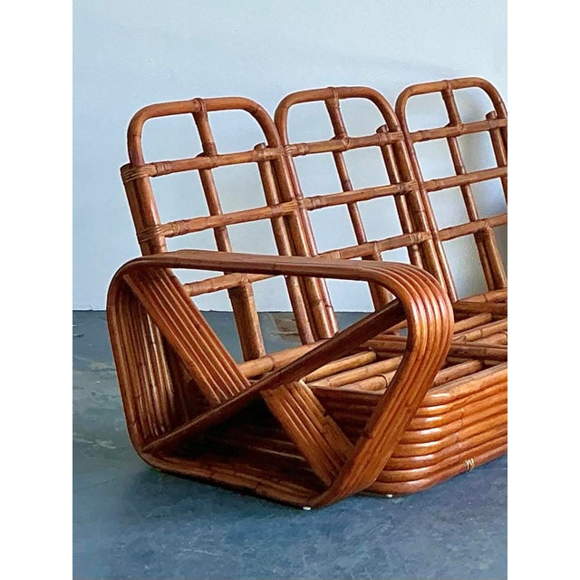 This exceptional Mid-Century Modern six-strand rattan sofa embodies the iconic "Tropical Modernism" aesthetic pioneered by...