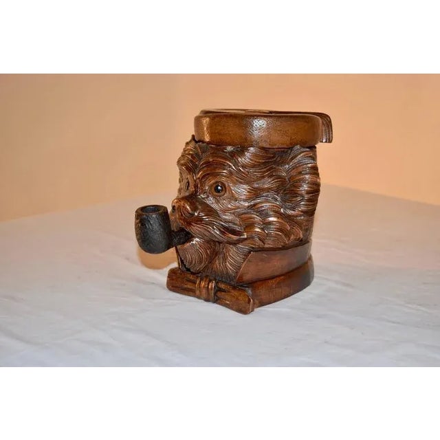 19th century black forest humidor hand-carved in the shape of a dog's head. His hat lifts to reveal storage for tobacco or...