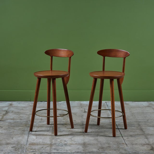 Pair of teak stools by Danish born designer Kurt Østervig for Brande Mobelindustri, c.1960s, Denmark. The stools feature a...