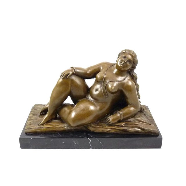 This solid bronze sculpture represents a naked woman lying in a relaxing pose in the taste of Botero. Made using the lost-...