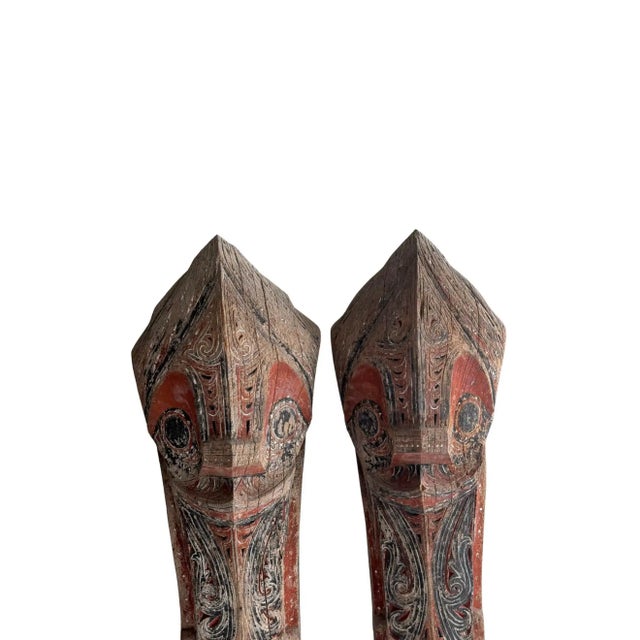 Mounted on custom black-painted metal stands, this striking pair of antique Singa sculptures originates from the Batak...