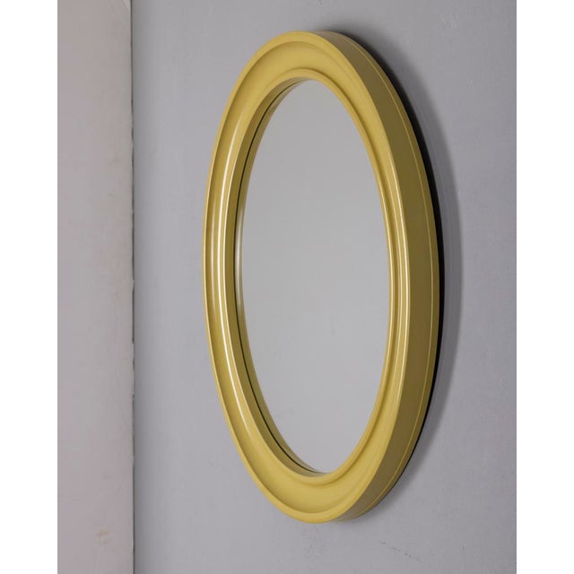 Oval wall mirror with green plastic frame, designed by Carrara Matta, 1970s.