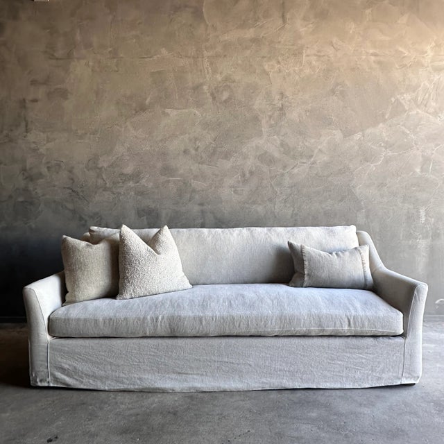 Introducing our slip-covered sofa in natural greige linen, with stone-washed linen for a relaxed, lived-in look. Sink into...