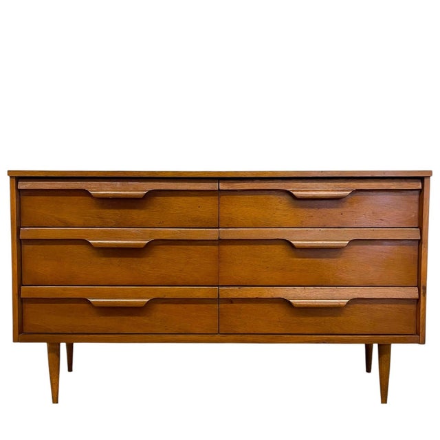 This vintage Mid Century Modern dresser by Bassett Furniture features a clean, low-profile silhouette with six spacious...