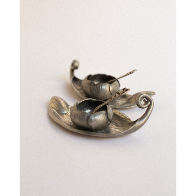 Made by the Parisian sculptors Alice Chanal and Eugène Louis Chanal, this pair of Art Nouveau salt cellars is cast in...