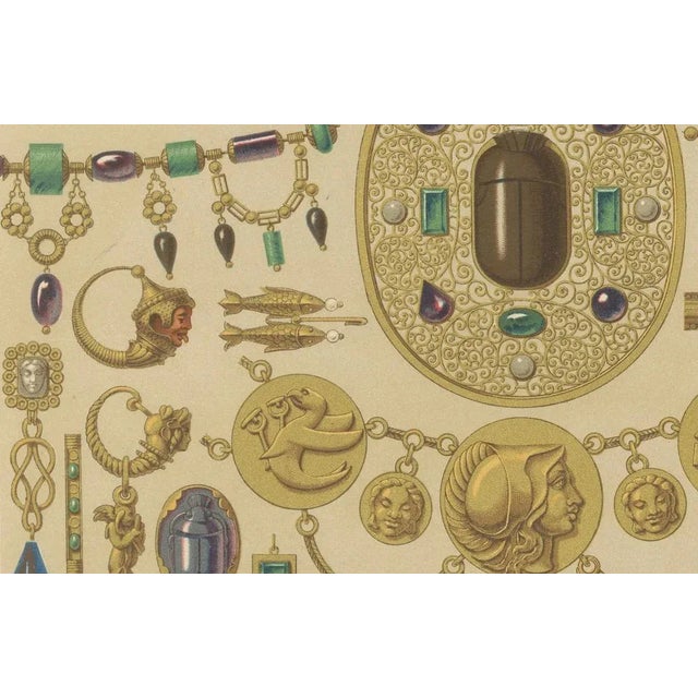 This lavish chromolithograph showcases the opulence and artistry of ancient Etruscan jewelry, meticulously reproduced in...