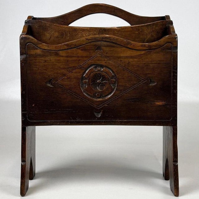 A handsome early 20th-century English magazine rack, finely crafted from solid oak and distinguished by its compact...