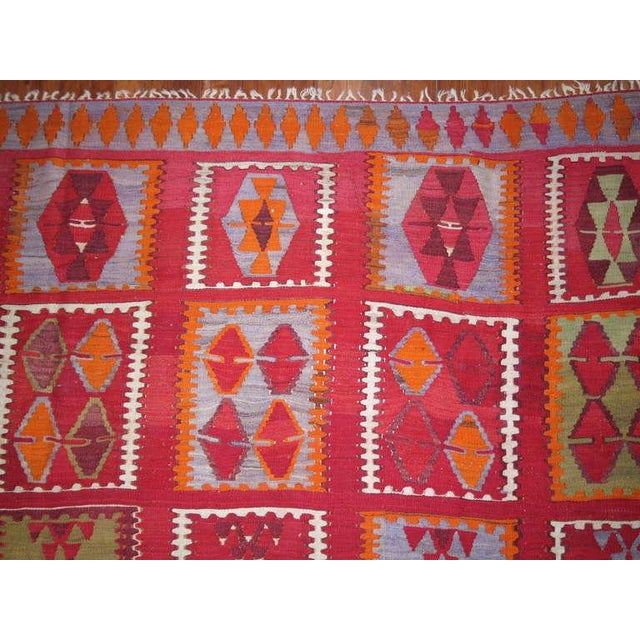 A fun-loving rather large handmade Turkish Kilim flat-weave in a hard to size find! Measures: 11'1'' x 14'1''.