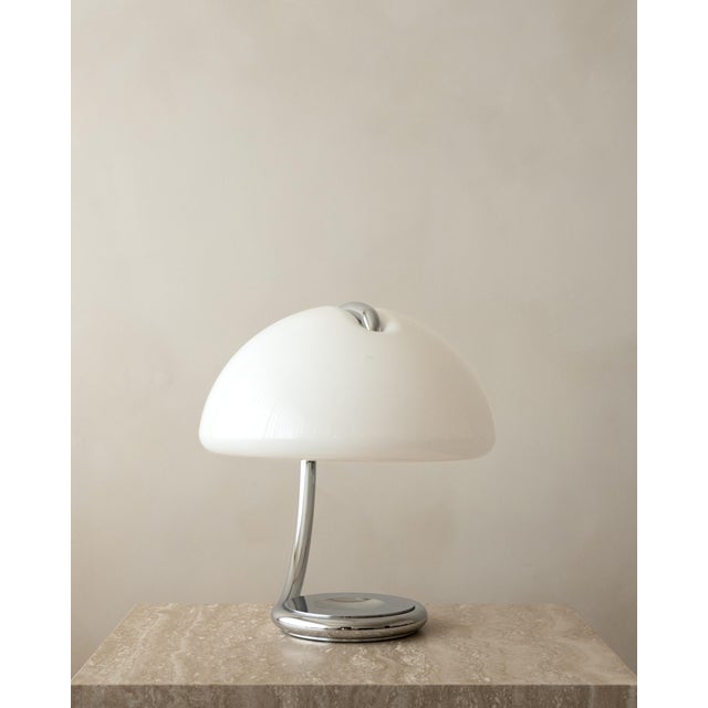 A vintage italian serpente model 599 table lamp in chrome-plated metal and opal white methacrylate, designed by elio...