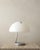 A vintage italian serpente model 599 table lamp in chrome-plated metal and opal white methacrylate, designed by elio...