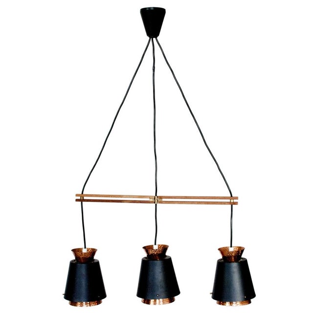Norwegian classic pendant lamp, from the mid-century. Pounded copper and black matte lampshade. Adjustable teak support...