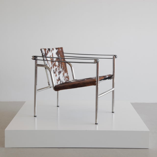 The iconic armchair uses a chrome-plated frame with back- and seat-cover upholstered in cowhide; the back can be tilted....