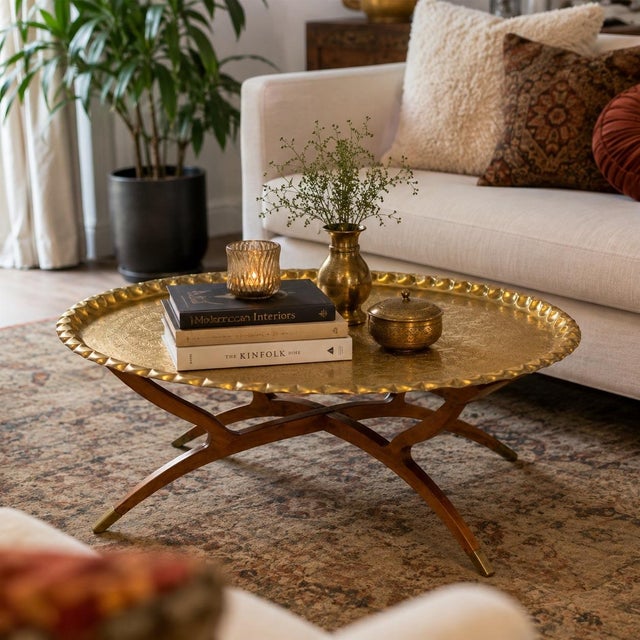 Striking vintage Moroccan brass tray table featuring a large hand-worked brass tray top set on an exceptionally sculptural...