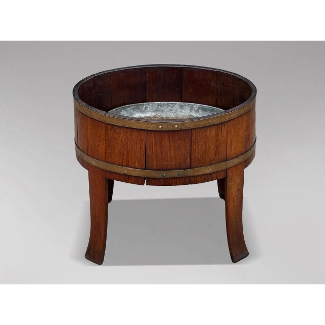 A fine Georgian Walnut Brass-Bound Oval Wine Cooler or Jardinière A fine Georgian oval wine cooler or jardinière in richly...