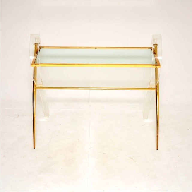 A stunning vintage Italian Lucite and gold finish console table, dating from the 1970’s. It has a very decorative style...