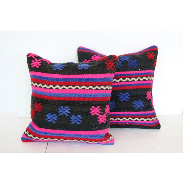 Pair of cushions made from a vintage handwoven Turkish kilim textile. Heavyweight cotton backs. Hidden zipper closures....