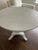 Round Swedish Neoclassical style painted round center/side table in pale gray with urn shaped pedestal base. Dimensions:...