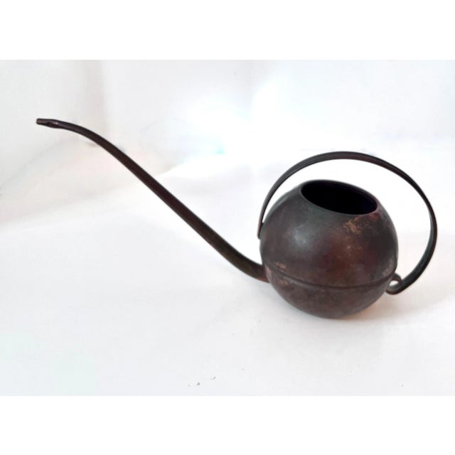 Vintage watering can of copper. The sleek lines and graceful handle make this piece a compliment to any garden setting as...
