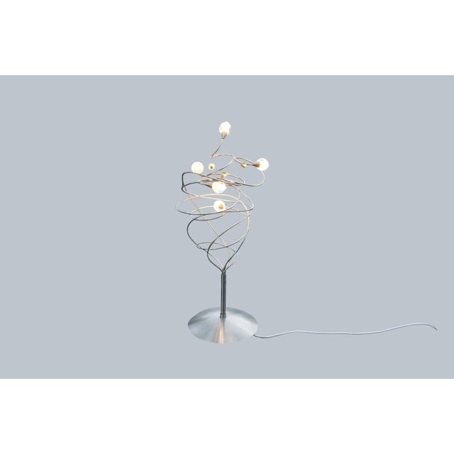 A sculptural table lamp by Harco Loor from the Netherlands, dated circa 1980. A spirally wound wire mesh with several...