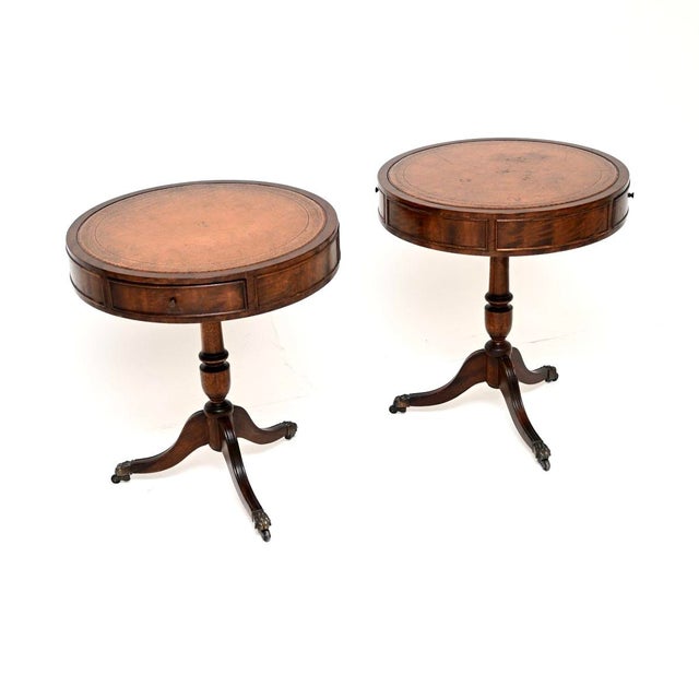 A lovely pair of antique leather top drum tables in the Regency style. They were made in England, and they date from...