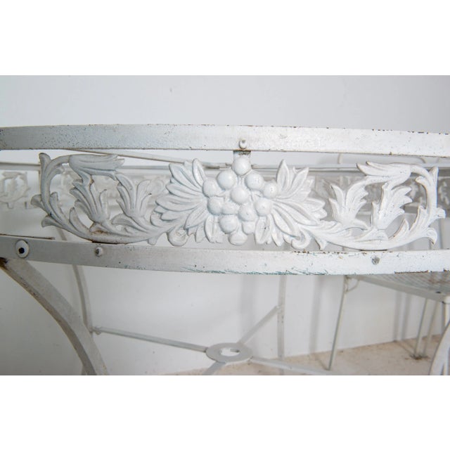 Stunning vintage 1940s wrought iron round table with grape and foliate decorated apron including a tempered glass top with...