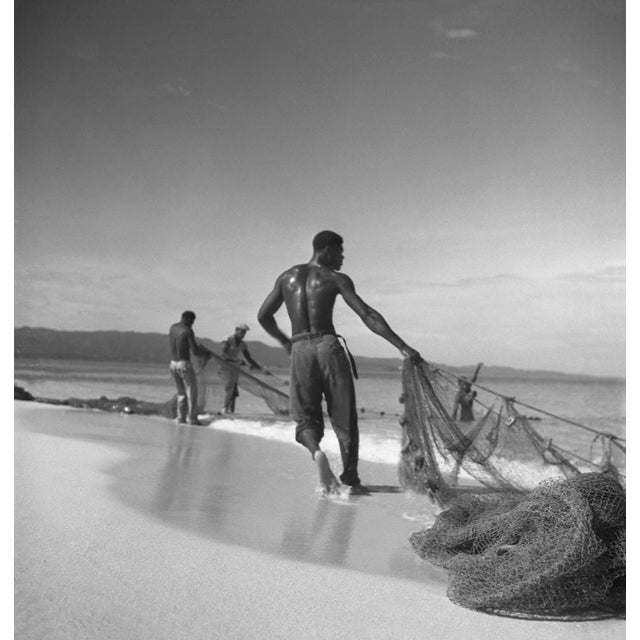 Montego Bay Fisherman by Toni Frissell Local fisherman bring in their nets on the beach in Montego Bay, 1948. (Toni...