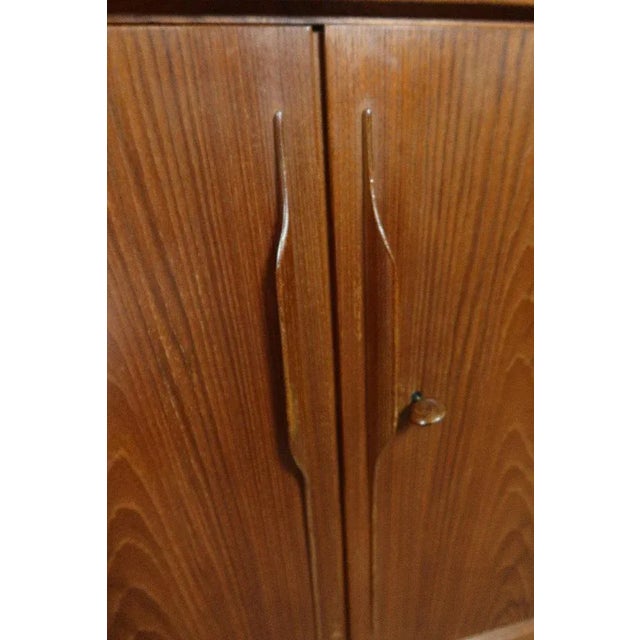 Sideboard in teak, opening by two doors and two drawers as well as a bar record. Nice construction for this piece of...