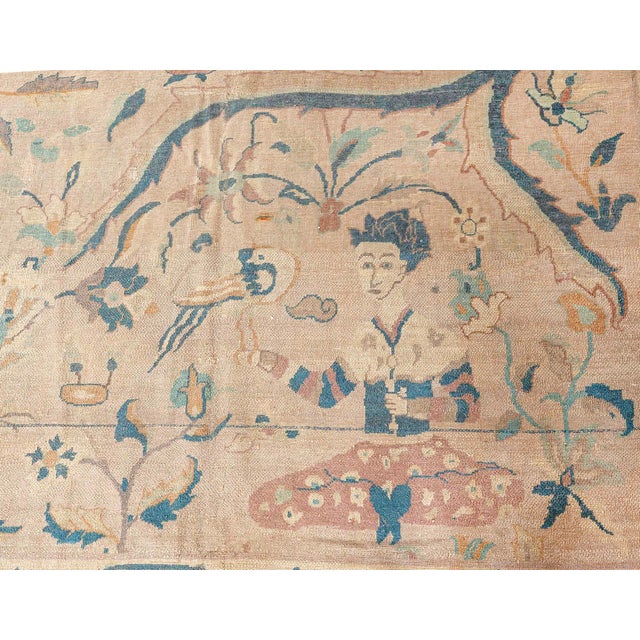 An early 20th century antique Indian hunting carpet, the camel field with an overall pattern of blue split leaves, floral...