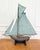 Made in England in the twentieth century, this model pond yacht takes the form of a gaff-rigged cutter, carved in wood and...