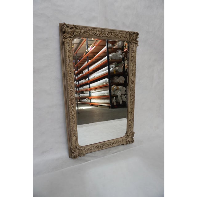 1940's Italian carved painted mirror The frame is a beige color with subtle hints of red coming through the carved design....