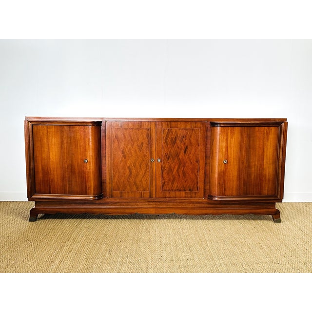 Art deco walnut sideboard dating from the 1930s. comprising four storage doors with shelves. the two outer doors feature a...