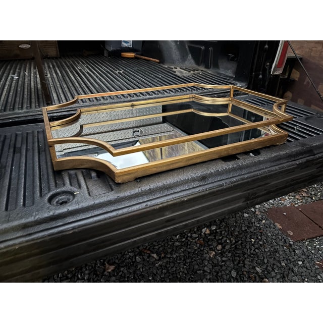 Gold Color Decorator Mirror in a Sleek Design . Made by the Uttermost Company .