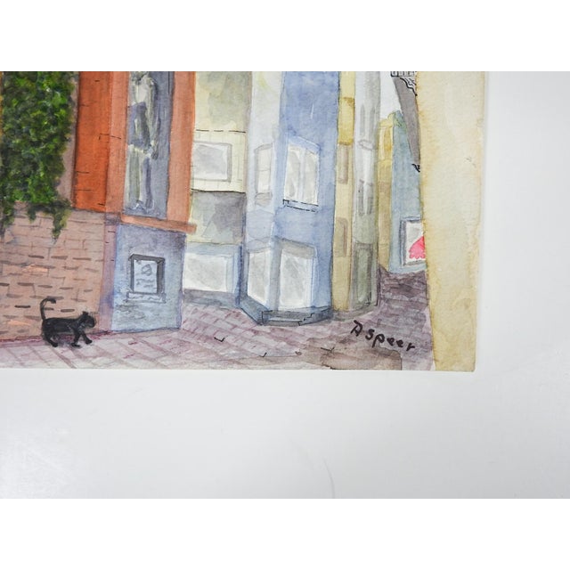 Late 20th century watercolor on paper painting of a continental cityscape with black cat. Signed P. Speer lower right....