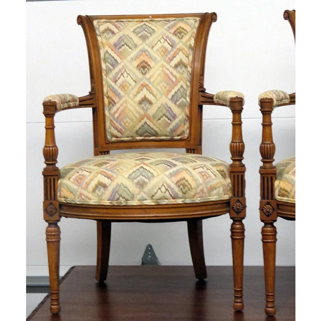 This elegant pair of French Regency style fauteuils armchairs reflects the refinement and grandeur of neoclassical design,...