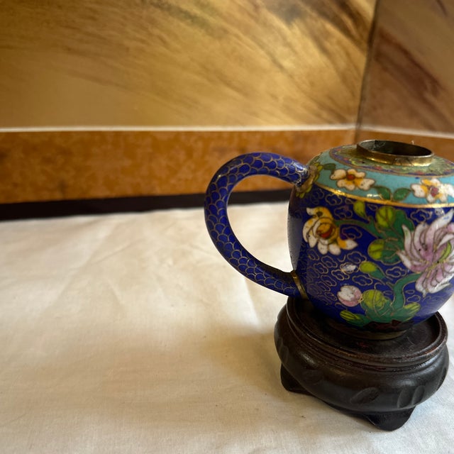 Up for consideration is a beautiful vintage blue cloisonné teapot with a wooden stand. This is a lovely accent piece for...
