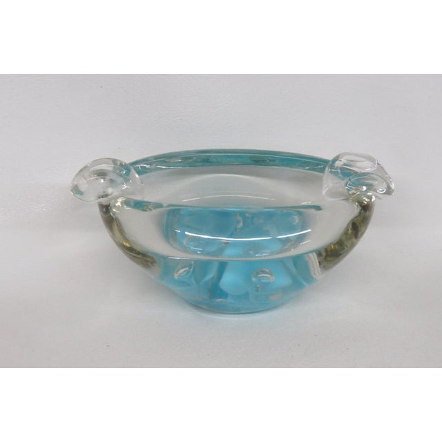 This magnificent collectible Glass Ashtray is made of blown art glass, and appears to be designed by artist Joe St. Clair....