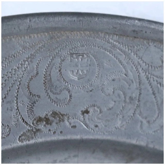 DETAILS An antique European pewter plate of round shape with an engraved and wrigglework medieval city scene of Schwäbisch...