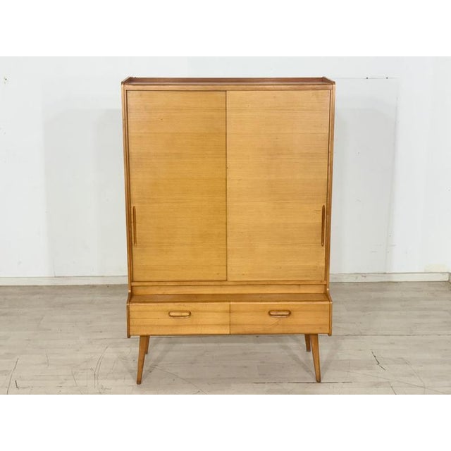 Beautiful vintage cabinet from the 1960s. This piece of furniture impresses with its typical mid-century design, the warm...