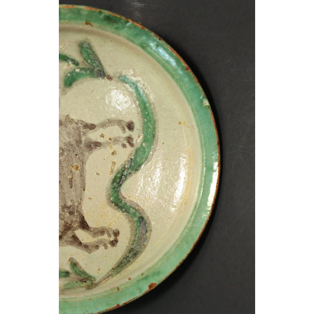 An amazing wheel thrown earthenware / redware bowl Grey glazed interior with primitively painted by hand brown bull in the...