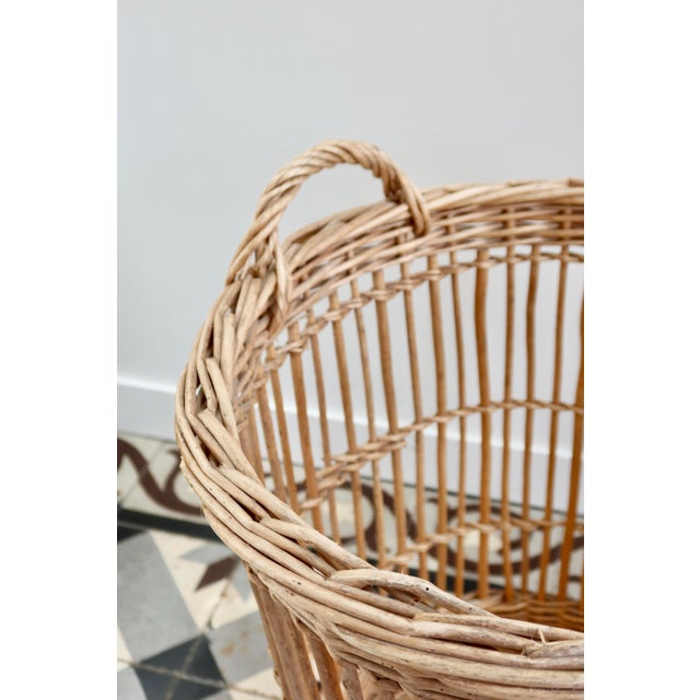 A French wicker bakery basket, once used to store and display baguettes, with a tall, slender shape and a beautiful...