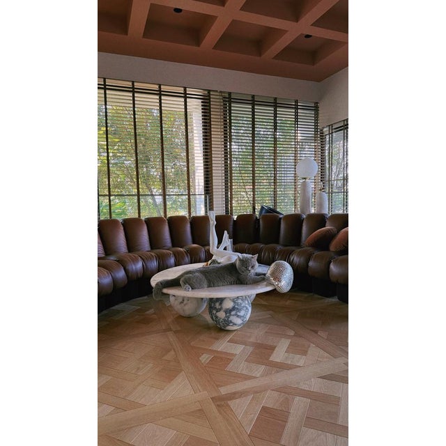 Crafted from a single material, this coffee table features a 3 cm thick bullnose-edged top, supported by three sculpted,...