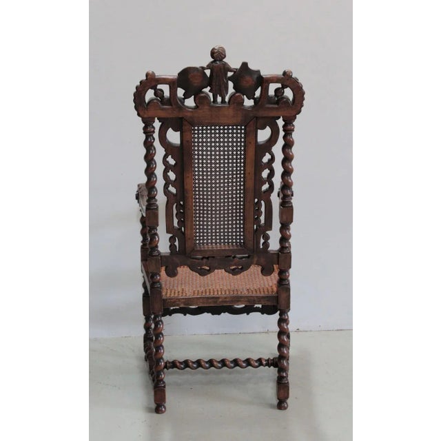 Large and elegant Louis XIII Style armchair in stained beech. The backrest and seat are made of cane and the barrel is...