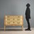 Neoclassical-style lacquered chest of drawers. Three curved drawers, the first with vertical carvings and gilded floral...