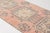 This is a vintage Turkish Oushak rug from the Mid 20th Century. The piece was hand-knotted.