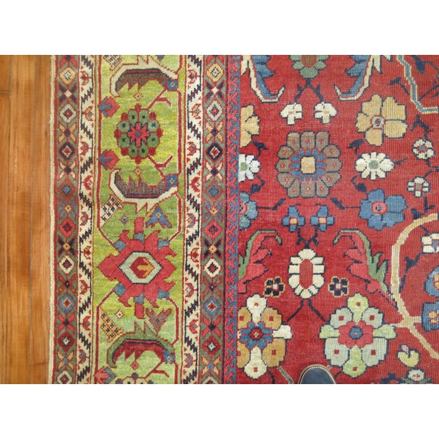 An early 20th century Persian Mahal rug with a red ground and light green abrashed border. 10'11'' x 172'' Exemplary...