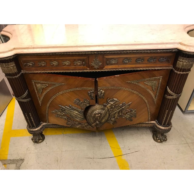 Very elegant Vintage credenza made of wood and bronze and marble top the piece is a beautiful piece you will love it. Made...